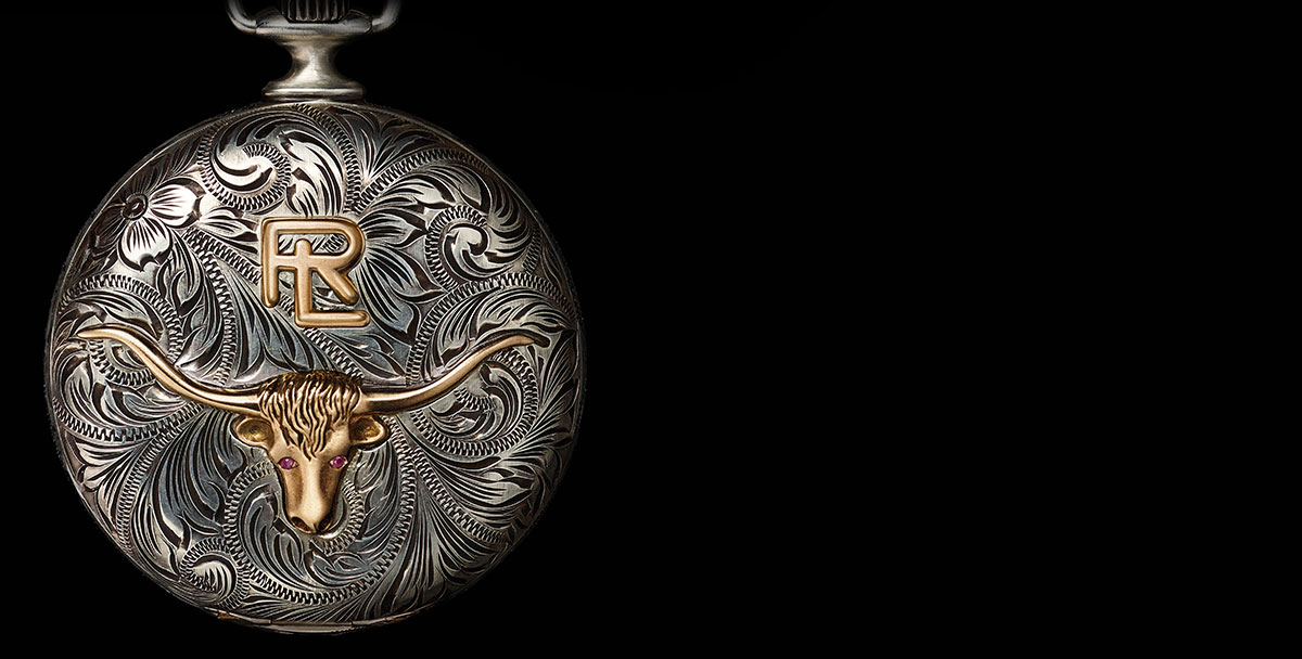 Pocket watch with intricate floral engravings and steer-head motif