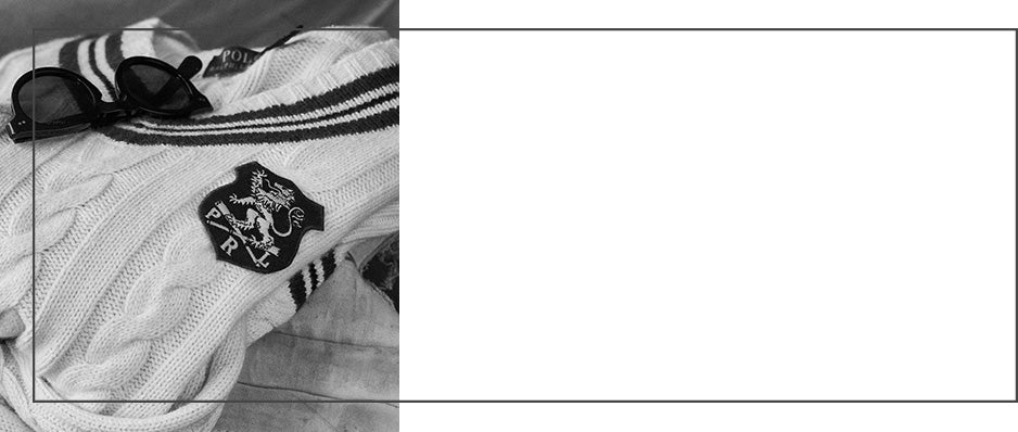 Close-up of cricket sweater with a lion crest patch at chest