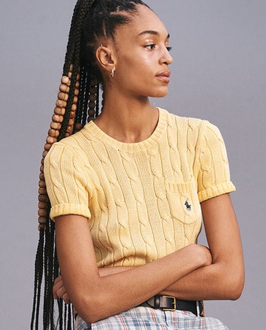 Woman in yellow cable short-sleeve sweater