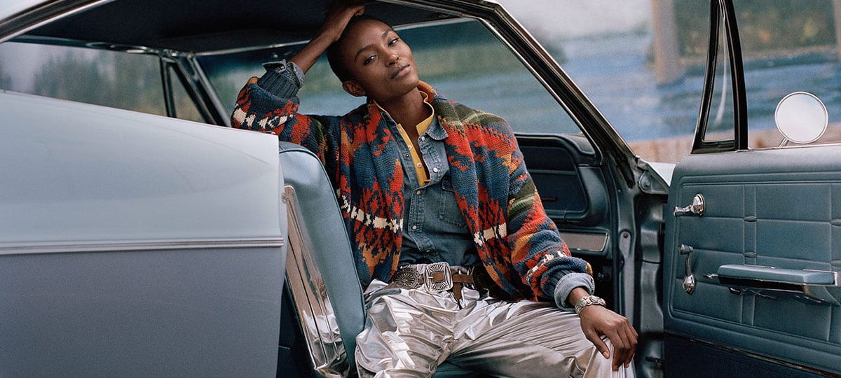 Woman in multicolored Southwestern-motif cardigan & denim shirt