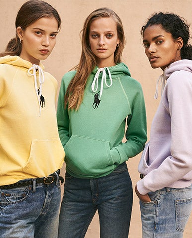 Women in faded pastel-hued hoodies & jeans