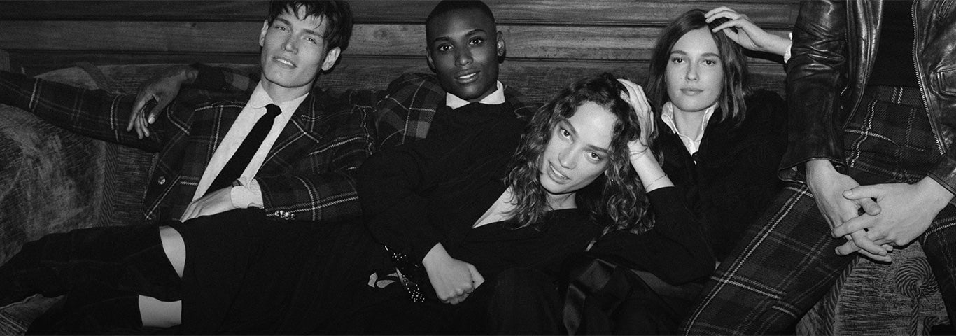 Women & men sitting on velvet couch in festive looks